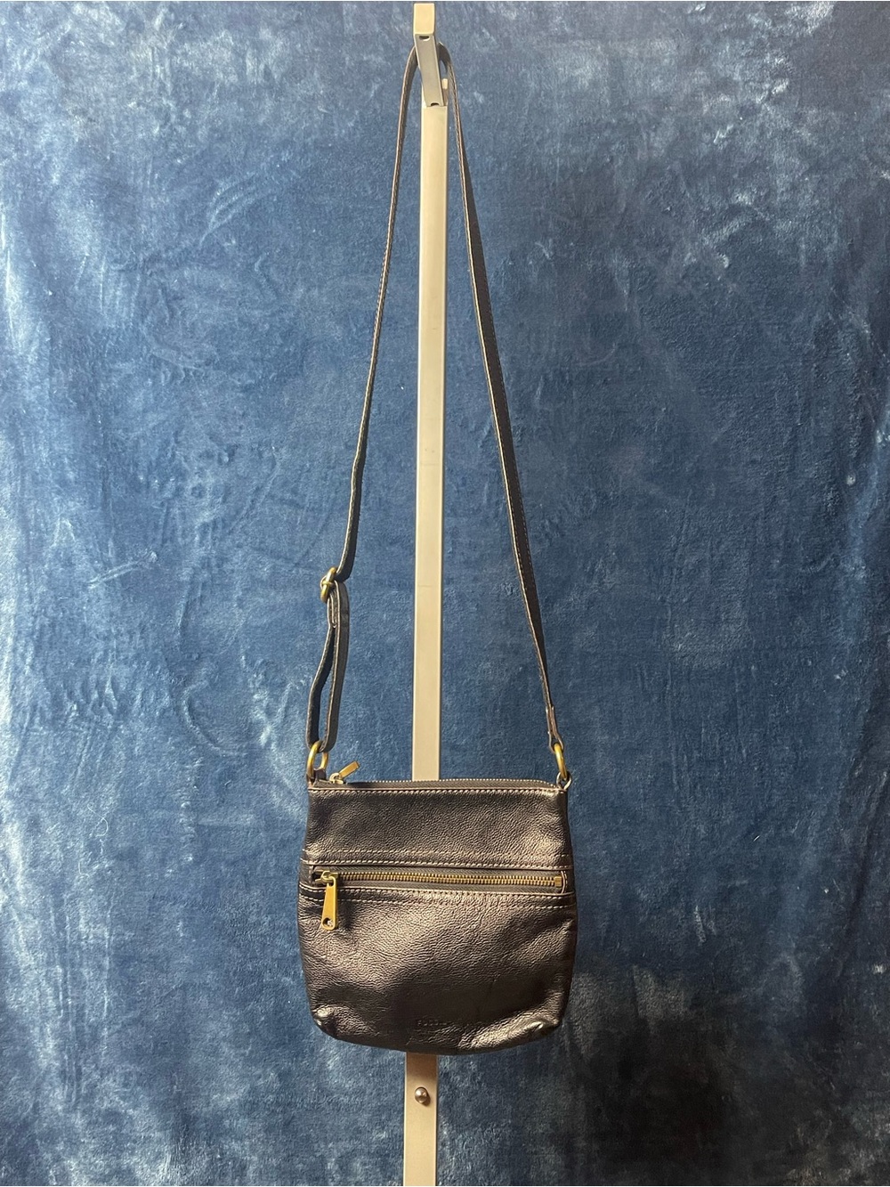 black pebbled leather Fossil Voyager crossbody bag featuring brass hardware
